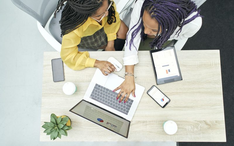 Top view of two young black women working in the office